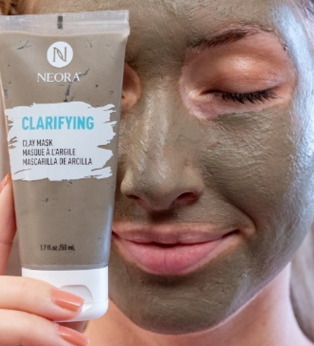 A woman wearing Clay Mask and holding Clay Mask infront of head